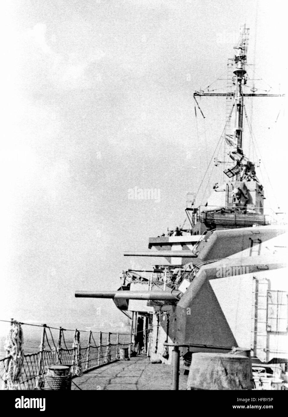 The forward gun turrets of the destroyer USS Monssen (DD-798) are ...