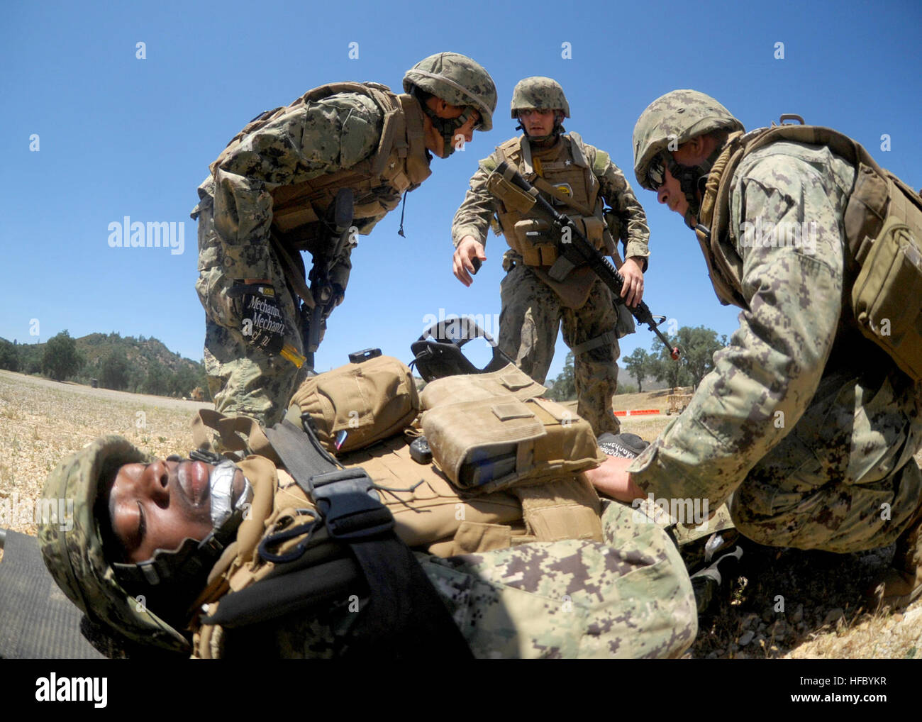 A combat litter team from Naval Mobile Construction Battalion 3 secures a  mock casualty during a simulated helicopter medical evacuation scenario.  NMCB 3 is conducting their final graded field training exercise (FTX),