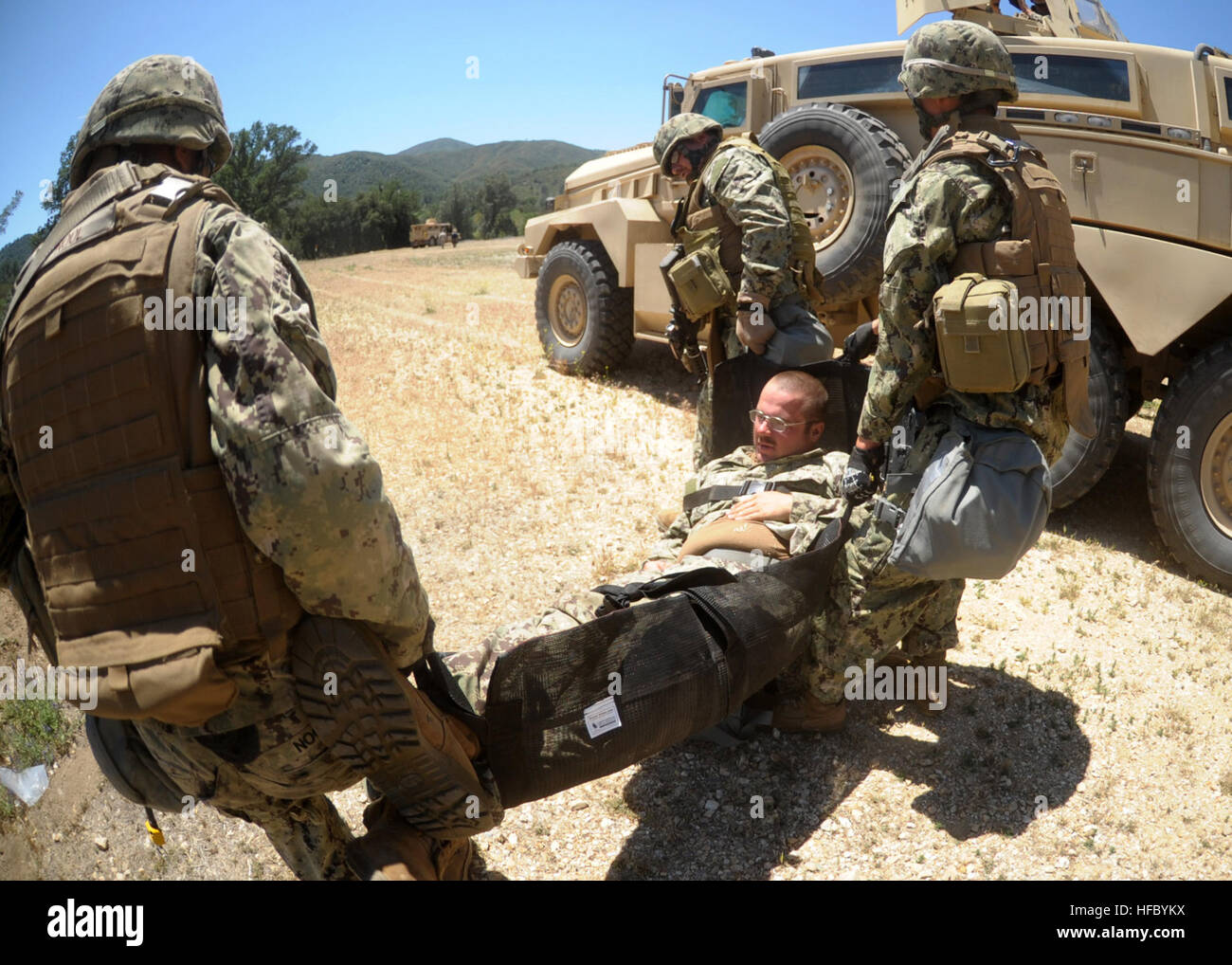 A combat litter team riding in a convoy from Naval Mobile Construction  Battalion 3 transports a mock casualty during a simulated helicopter  medical evacuation scenario. NMCB 3 is conducting their final graded