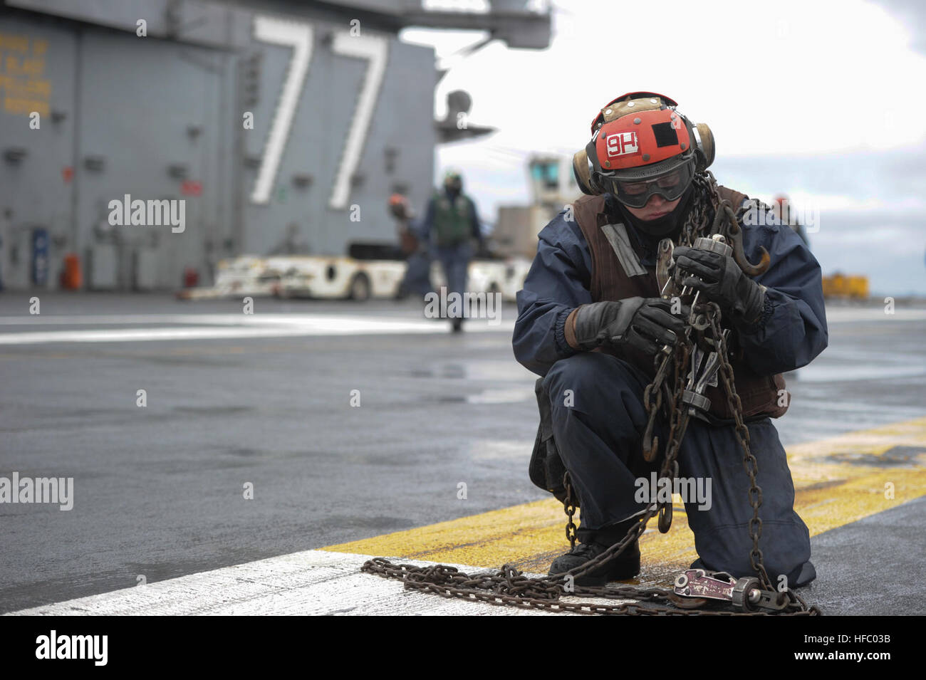 150205-N-IJ275-023  ATLANTIC OCEAN (Feb. 5, 2015) Aviation Ordnanceman Airman Clinton Endl, from Meridian, Wis., puts chains away on the flight deck aboard the aircraft carrier USS George H.W. Bush (CVN 77). George H.W. Bush is conducting training operations in the Atlantic Ocean.  (U.S. Navy photo by Mass Communication Specialist Seaman Ciarra C. Thibodeaux/Released) George H.W. Bush is conducting training operations in the Atlantic Ocean 150205-N-IJ275-023 Stock Photo