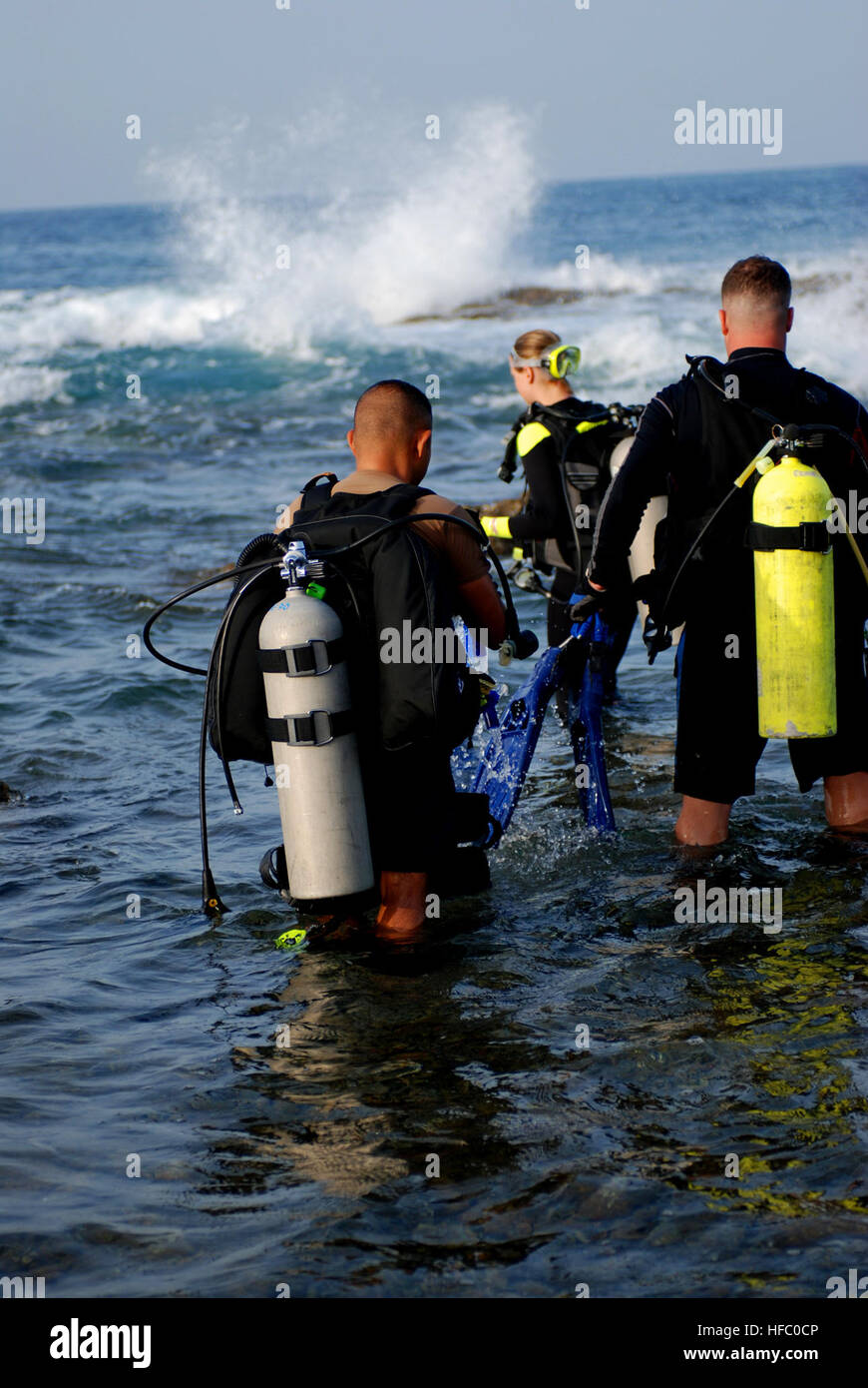 Kazuaki Sugiyama, Sarah Cleveland and Paul Hurlburtt prepare to enter “the Slot,” a dive site off the coast of U.S. Naval Station Guantanamo Bay, May 10, 2008. Guantanamo Bay has an extensive dive program, offering certifications ranging from open water diver to master diver. JTF Guantanamo conducts safe and humane care and custody of detained enemy combatants. The JTF conducts interrogation operations to collect strategic intelligence in support of the Global War on Terror and supports law enforcement and war crimes investigations. JTF Guantanamo is committed to the safety and security of Ame Stock Photo