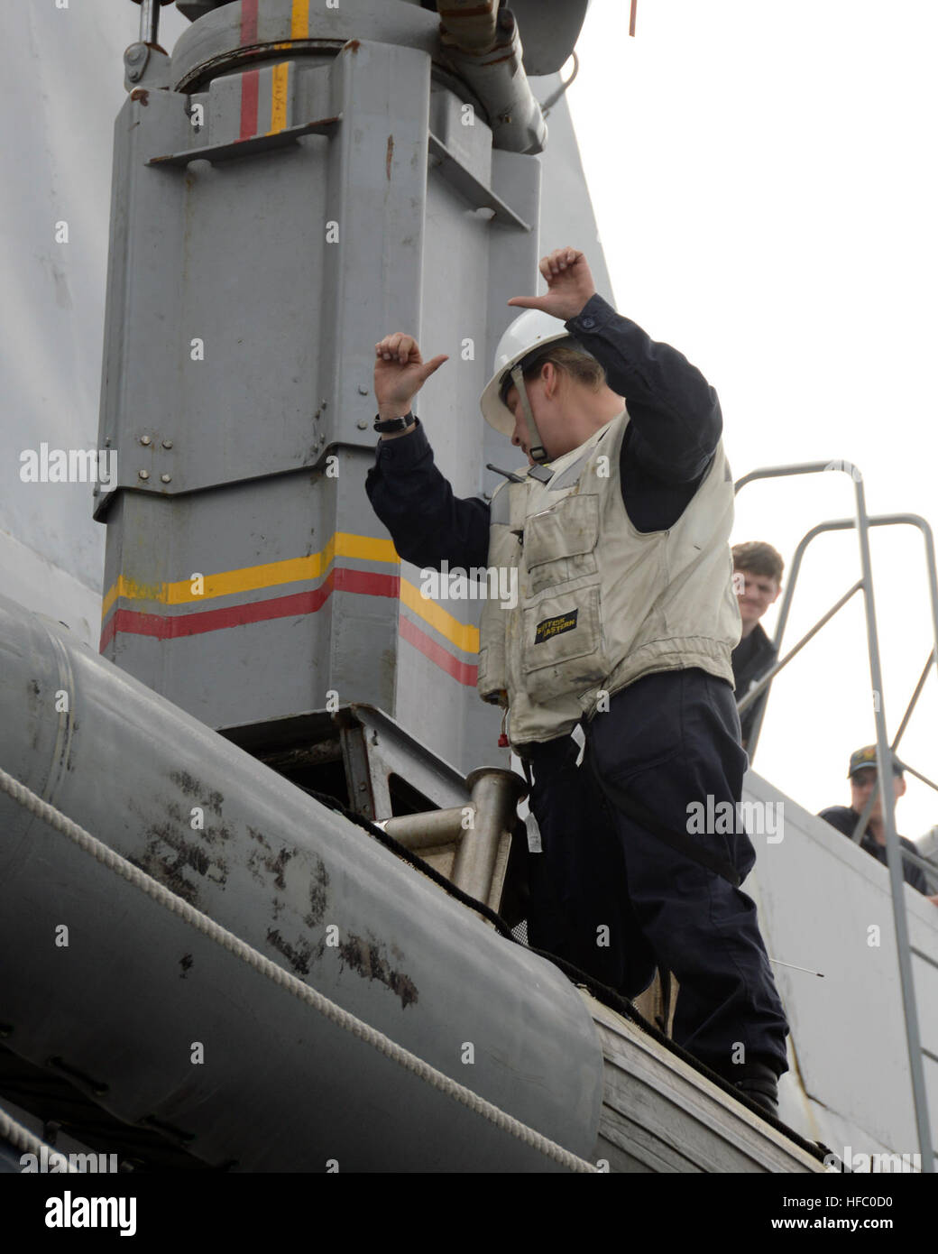 U.S. Navy Boatswain's Mate 1st Class Billi Nordhoff, front, gives
