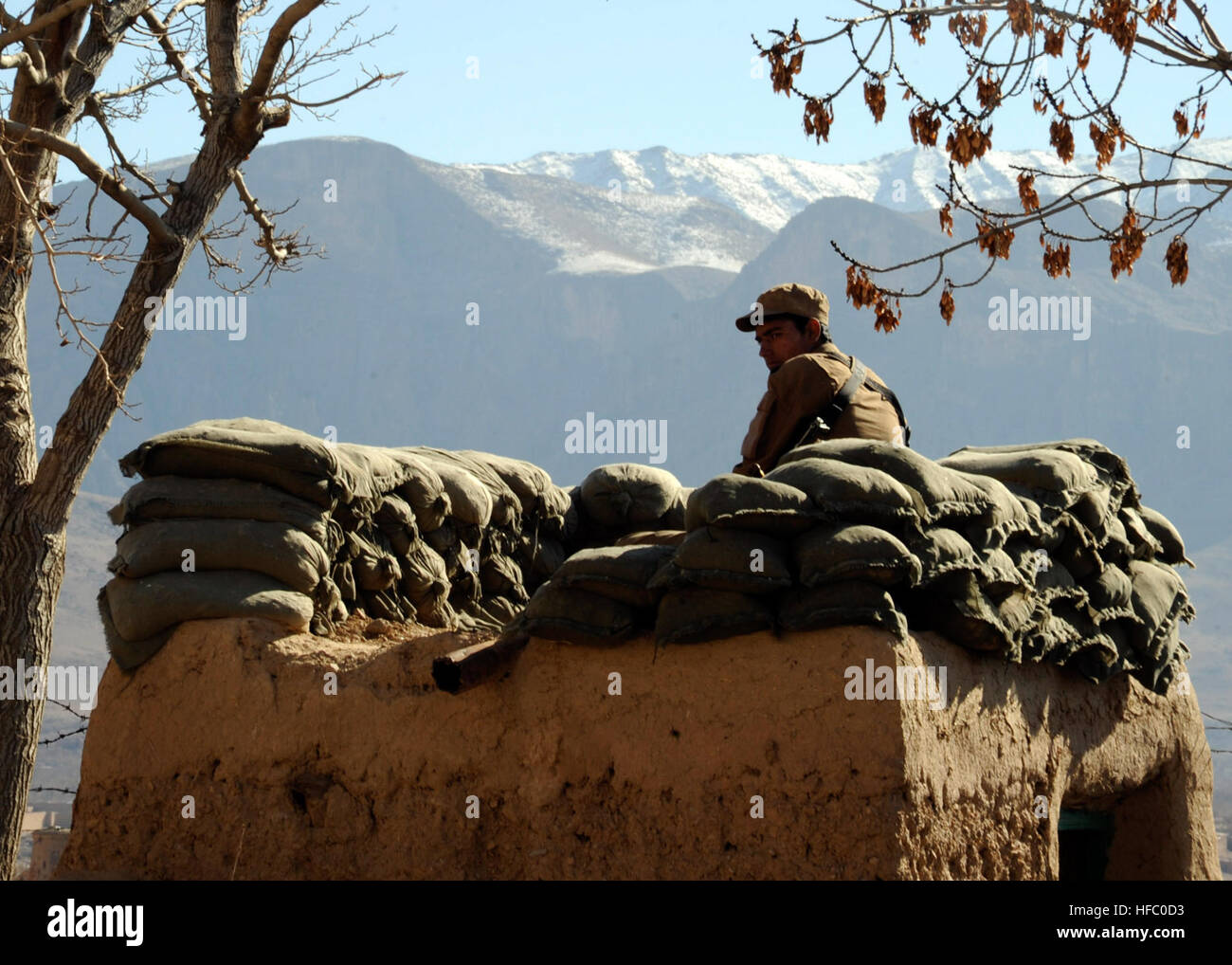An Afghan Local Police officer stands a security watch outside of a shura in Gizab district, Uruzgan province, Afghanistan, Jan. 18. The shura was held to distribute district teachers' salaries and educational textbooks. Gizab district teacher pay day 120118-N-MY805-131 Stock Photo