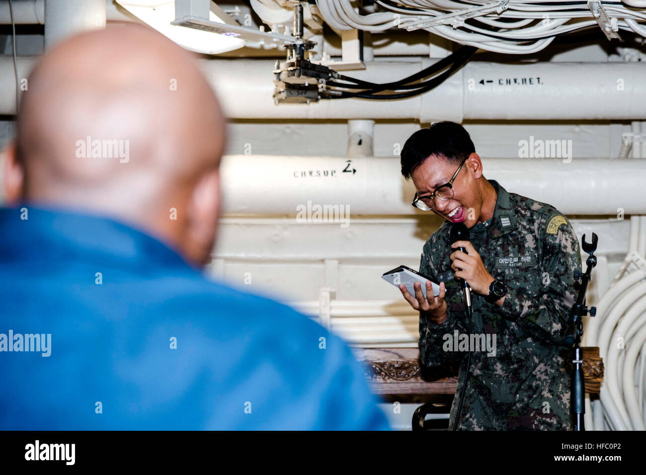 WATERS OUTSIDE OF OKINAWA (Aug. 12, 2016) Republic of Korea (ROK) Midshipman In Woo Song sings a song during Open Mic Night aboard the amphibious transport dock ship USS Green Bay (LPD 20). Green Bay, part of the Bonhomme Richard Expeditionary Strike Group, is operating in the U.S. 7th Fleet area of operations in support of security and stability in the Indo-Asia-Pacific region. (U.S. Navy photo by Mass Communication Specialist 1st Class Chris Williamson/Released) Green Bay Underway 160812-N-JH293-290 Stock Photo