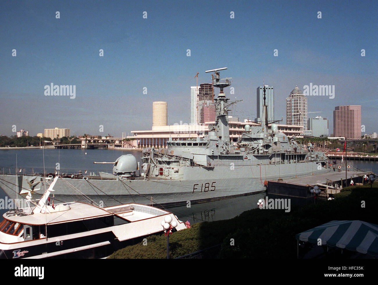 The British frigate HMS Avenger (F-185) lies tied up near a civilian vessel during it visit to the city. HMS Avenger (F185) at Tampa Bay 1992 Stock Photo