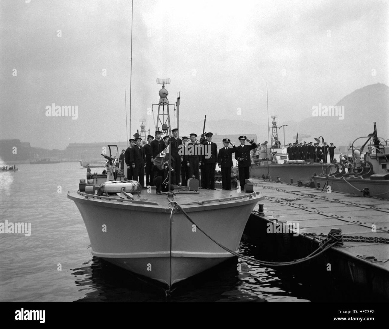 Personnel of ROK Navy stand at attention on board PT boat while Korean nationa anthem is played .  Four patrol torpedo boats were added to ROK Navy when V.Adm. Won IL Sohn, ROKN, accepted the vessels from U.S. Naval authorities in Sasebo, Japan.  The transfer was made by R.Adm. George C. Dyer, USN. NARA FILE #:  80-G-438008 HN-SN-98-07196 Stock Photo