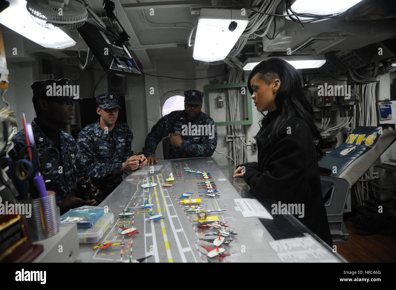 Sailors aboard the Nimitz-class aircraft carrier USS George Washington (CVN 73) discuss the Ouija board with singer/actress Robyn 'Rihanna' Fenty during a post press conference tour of the ship. George Washington hosted a news conference between 150 international journalists and the director and cast of the movie Battleship on the flight deck of the Navy's only full-time forward deployed aircraft carrier. (U.S. Navy photo by: Mass Communication Specialist Seaman Apprentice Brian H. Abel/Released) 'Battleship' stars aboard USS George Washington 120402-N-ZT599-390 Stock Photo