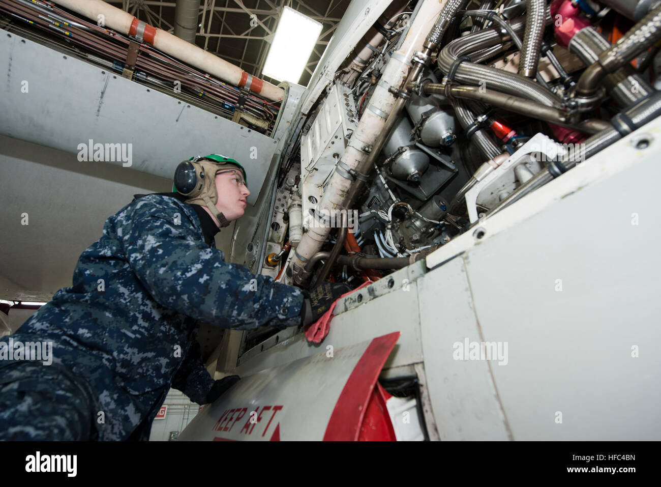 Aviation Machinist's Mate 2nd Class Jason Snedeker, from Fleet Logistics Support Squadron (VRC) 30, Detachment 5, performs maintenance on the hydraulic system of a C-2A Greyhound inside the squadron's hangar. VRC-30 is responsible for transporting cargo, mail and passengers to and from U.S. Pacific Fleet aircraft carriers. (U.S. Navy photo by Mass Communication Specialist 3rd Class Ryan G. Greene/Released) Hydraulic system maintenance 140207-N-EI558-006 Stock Photo