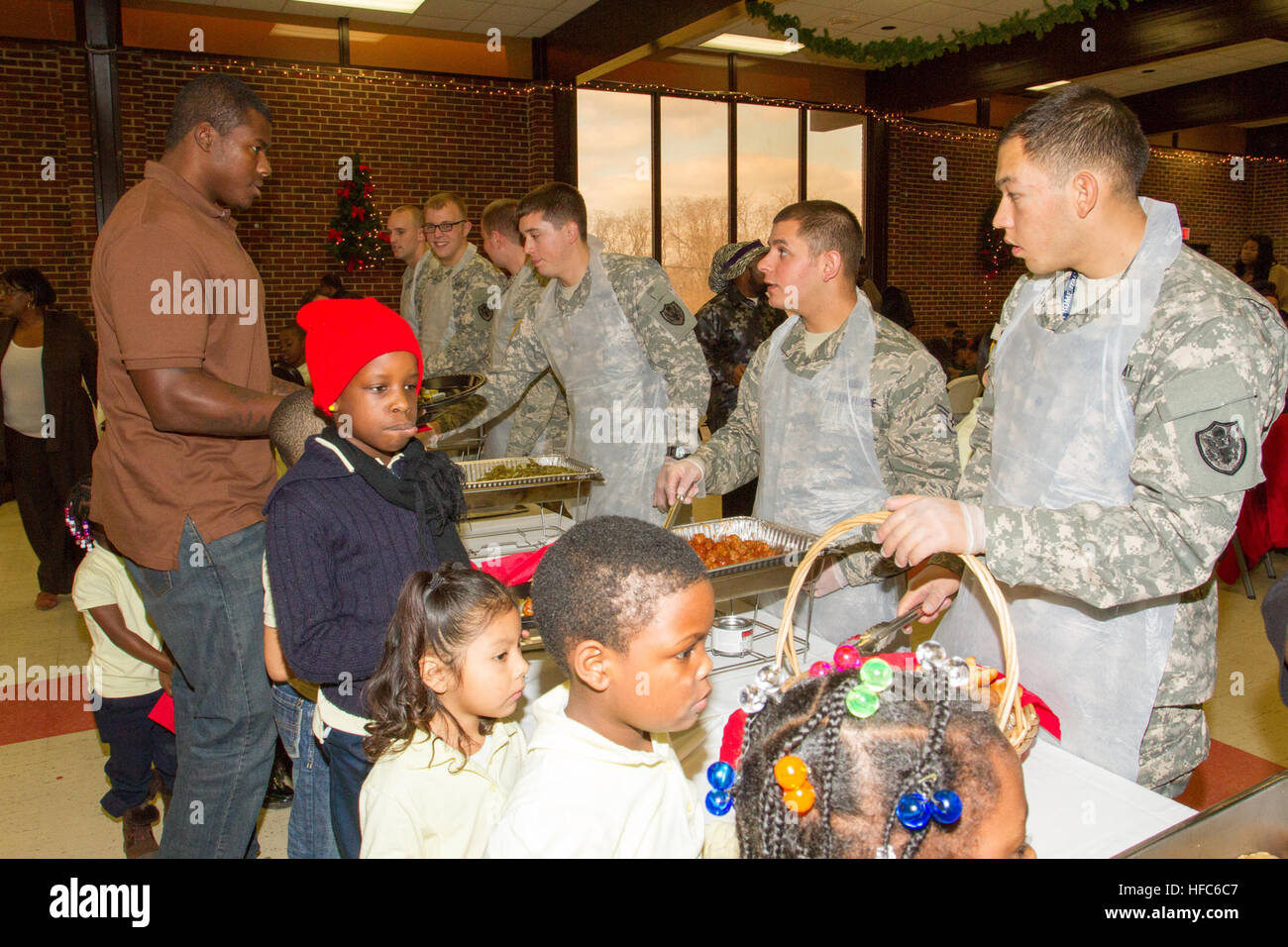Military and civilian personnel and their families, living or working at Joint Base Anacostia-Bolling volunteered and helped make the Christmas holiday season more joyful for nearly 300 youth in the District of Columbia's Ward 8 at a Disadvantaged Youth Holiday Party, sponsored by the Metropolitan Police Department's Seventh District Dec. 18. The JBAB volunteers helped serve food to the children; pass out gifts and help with the distribution of 80 bicycles donated to the Marine Corps Foundation's Toys for Tots program for the neediest of the children. The JBAB-based U.S. Air Force Rock Band, M Stock Photo