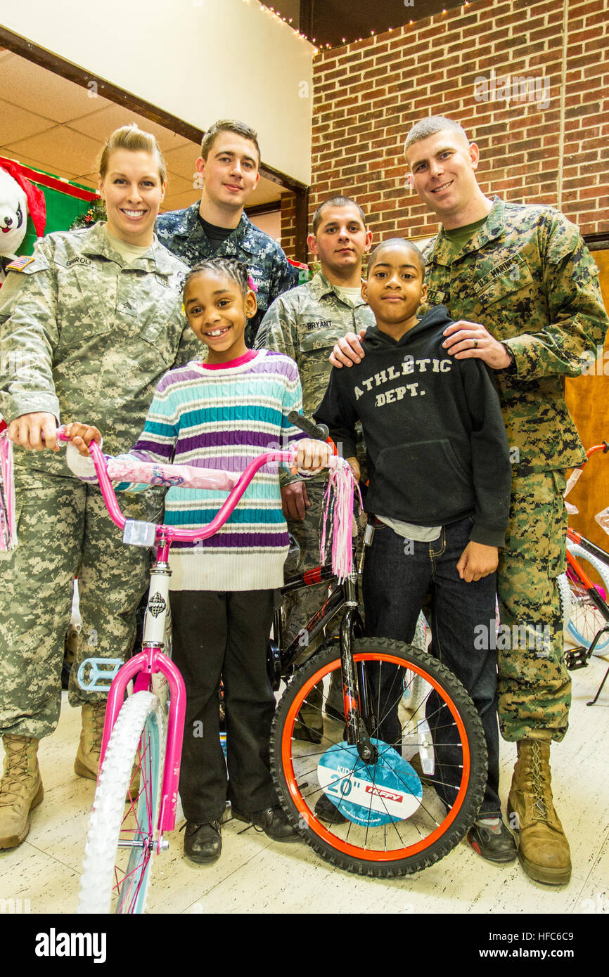 Military and civilian personnel and their families, living or working at Joint Base Anacostia-Bolling (JBAB) volunteered and helped make the Christmas holiday season more joyful for nearly 300 youth in the District of Columbia's Ward 8 at a Disadvantaged Youth Holiday Party, sponsored by the Metropolitan Police Department's Seventh District on Dec. 18. The JBAB volunteers helped serve food to the children; pass out gifts and help with the distribution of 80 bicycles donated to the Marine Corps Foundation's Toys for Tots program for the neediest of the children. The JBAB-based U.S. Air Force Ro Stock Photo