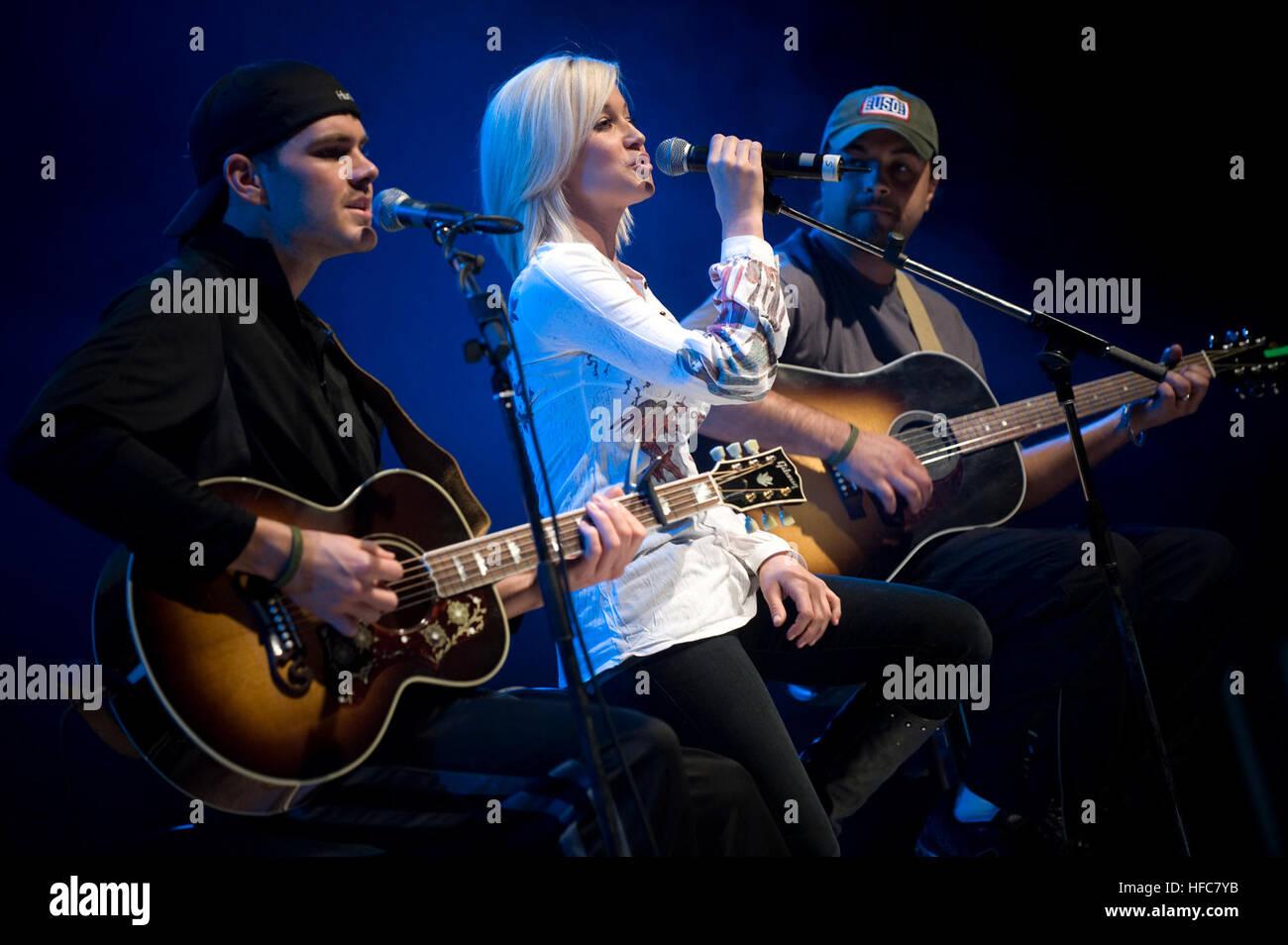 081216-N-0696M-299 American Idol contestant and country musician Kellie Pickler and band mates Joshua Henson (left) and Ryan Ochsner perform for service members during the 2008 USO Holiday Tour stop at Ramstein Air Force Base, Germany. Tour host U.S. Navy Adm. Mike Mullen, chairman of the Joint Chiefs of Staff and his wife Deborah were also joined by comedians Lewis Black, Kathleen Madigan and John Bowman; Actress Tichina Arnold and Grammy award winning musician Kid Rock on the tour bringing joy to service members and their families stationed overseas. (DoD photo by Mass Communication Speciali Stock Photo