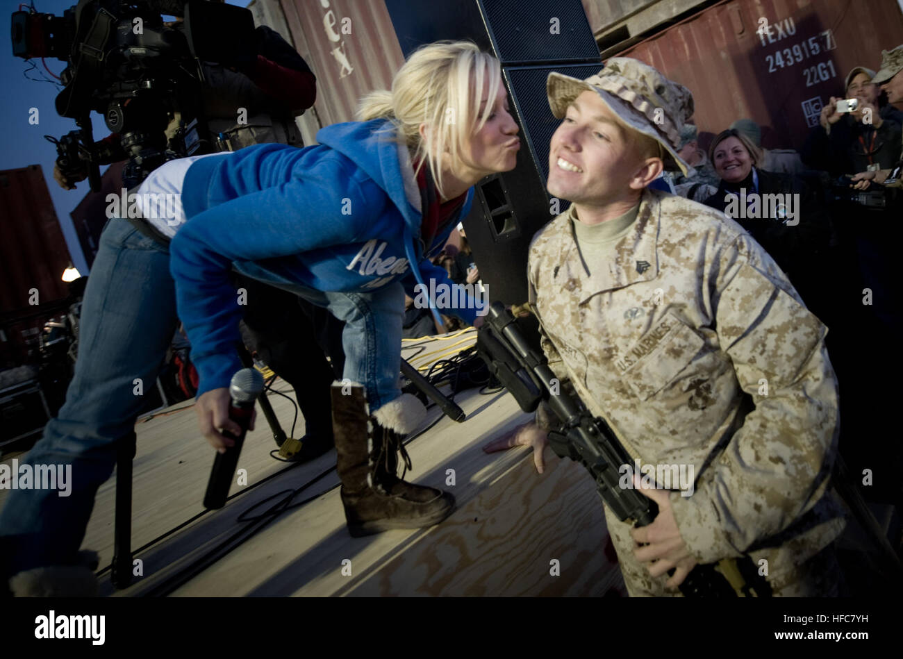 081219-N-0696M-394 American Idol contestant and country musician Kellie Pickler grants a Christmas wish for a kiss to U.S. Marine Sgt. Christopher Lambert at the   2008 USO Holiday Tour stop at Al Asad Air base, Iraq, Dec. 19, 2008. Tour host U.S. Navy Adm. Mike Mullen, chairman of the Joint Chiefs of Staff and his wife Deborah welcomed musician Zack Brown; comedians John Bowman, Kathleen Madigan and Lewis Black; actress Tichina Arnold; and Grammy award winning musician Kid Rock on the tour bringing music and entertainment to service members and their families stationed overseas. (DoD photo by Stock Photo