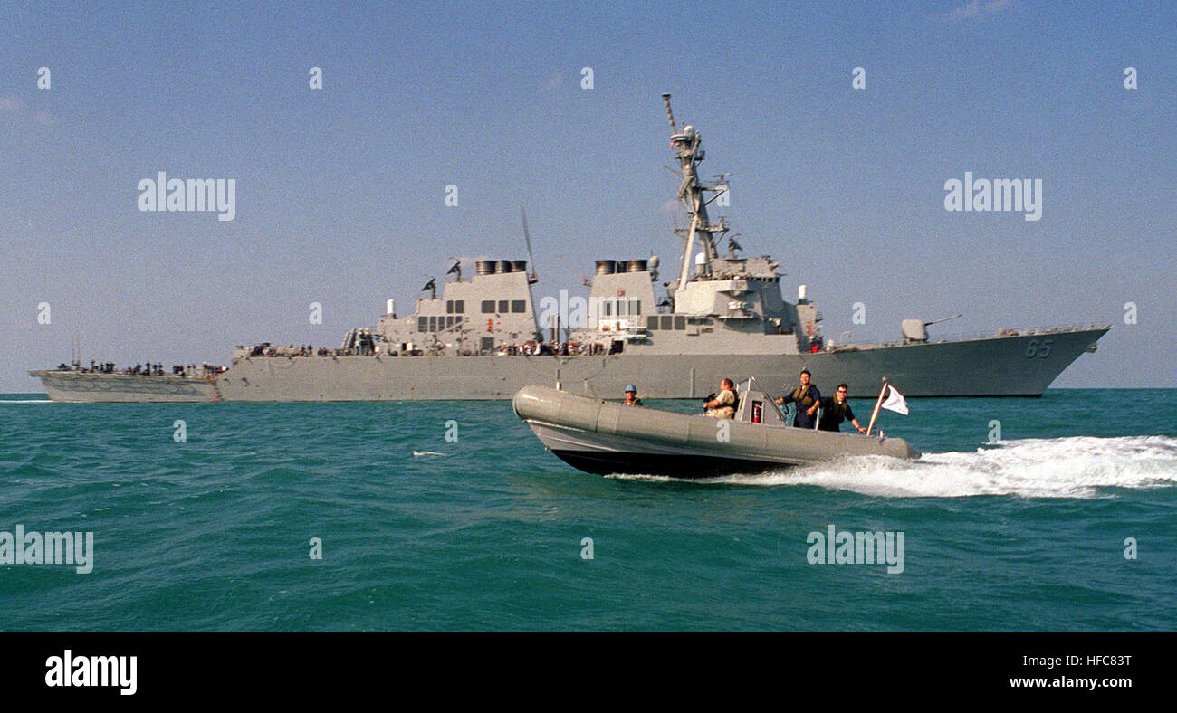 A Rigid Hull Inflatable Boat (RHIB) passes the U.S. Navy destroyer USS ...
