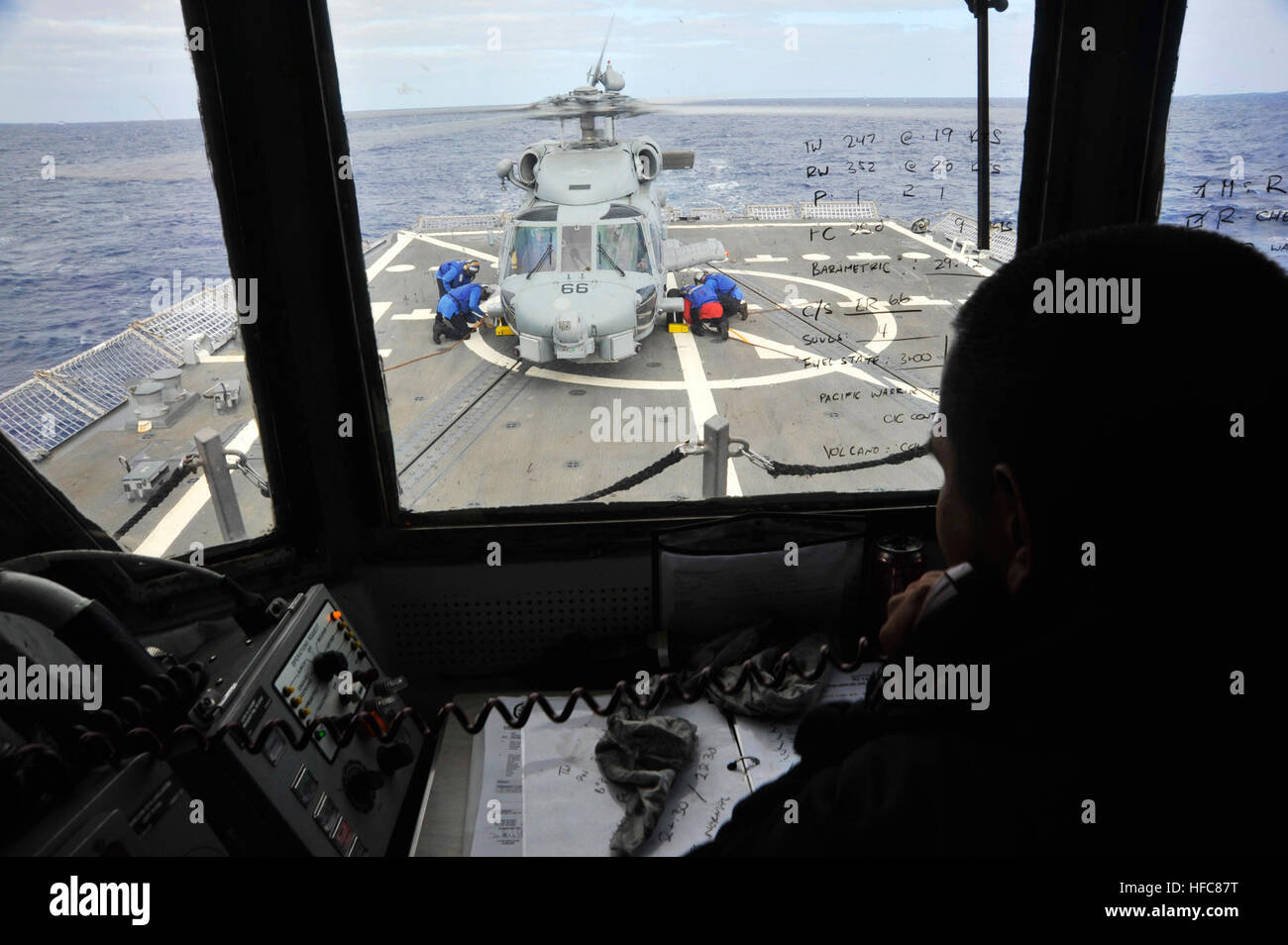 Helicopter control officer Lt. j.g. Vincent Tes supervises sailors on