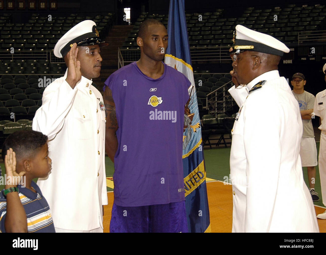 051007-N-6775N-010 Honolulu, Hawaii (Oct. 7, 2005) Ð National Basketball Association (NBA) star Kobe Bryant accompanies U.S. Navy Chief Yeoman Lawrence A. Sivils and his son while being sworn in during his reenlistment at the University of Hawaii, Manoa's Stan Sheriff Center. Chief Sivils, who is assigned to the staff of Seal Delivery Vehicle Team One, is a fan of the Lakers and Kobe Bryant.  The Lakers were in Honolulu for an upcoming exhibition game. U.S. Navy photo by Photographer's Mate 2nd Class Justin P. Nesbitt (RELEASED) Kobe Bryant 05 Stock Photo