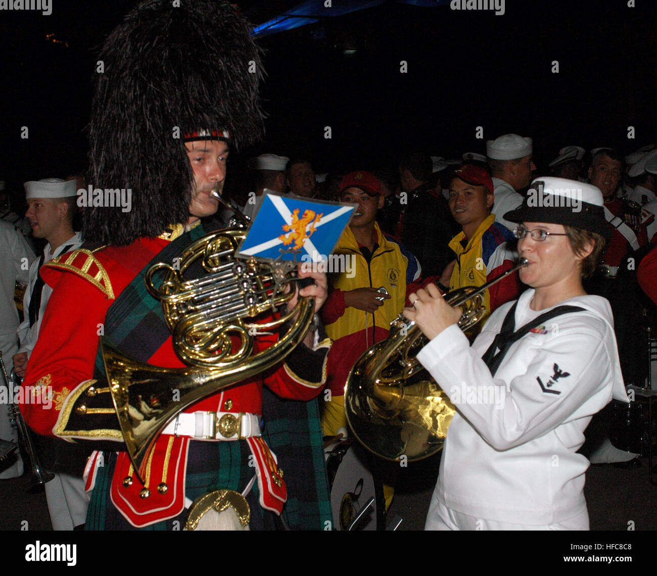 Petty Officer 3rd Class Helena Giammarco, musician in the Pacific Fleet band, plays the French horn backstage with a friend from the Royal Regiment of Scotland following the second night of performances at the Kuala Lumpur International Tattoo 2007. The Tattoo, scheduled for Sept. 6-8, celebrates the 50th anniversary of Malaysia's independence and features international military bands from the United States, Jordan, Brunei, France, India, the Republic of the Philippines, the Republic of Singapore, the Kingdom of Thailand, Korea, the Islamic Republic of Pakistan, the United Kingdom, and a Maori Stock Photo