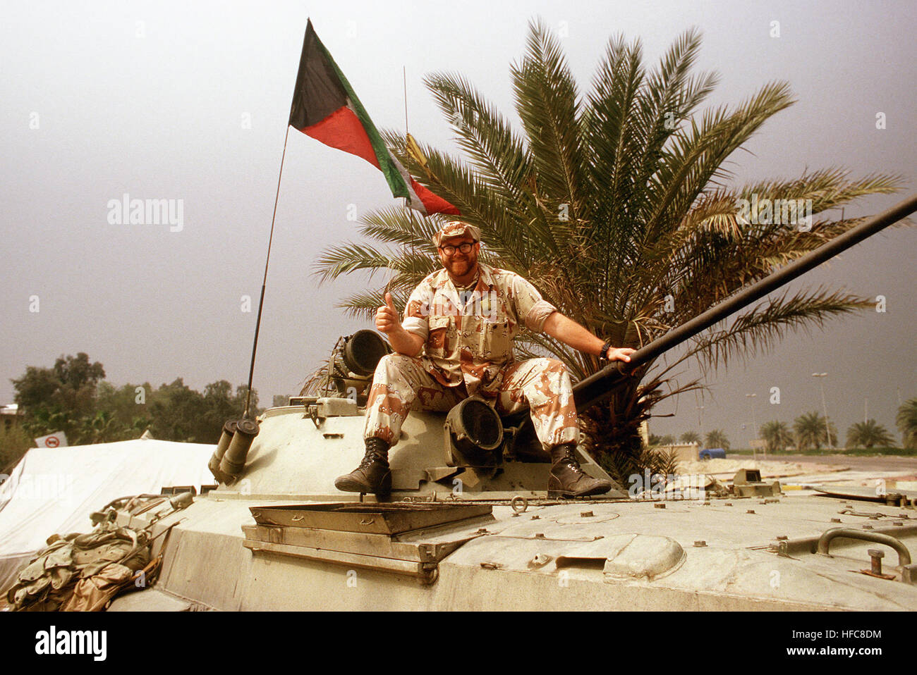 Photographer's Mate 2nd Class Milton R. Savage, a Navy Reserves photographer, sits atop a captured Iraqi BMP-2 Infantry fighting vehicle during the cease fire concluding Operation Desert Storm. Kuwaiti BMP-2 2 Stock Photo