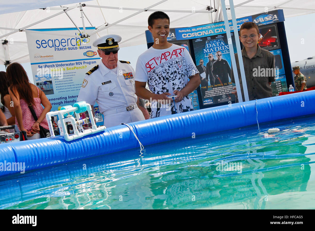 120519-N-BA377-068 MARCH AIR RESERVE BASE, Calif. (May 19, 2012) Lt. Bob Dunn, division operations officer for the U.S. Naval Sea Cadet Corps Paul Revere Division, looks on as a boy pilots a SeaPerch underwater robot at the division's exhibit during March Field Air Fest 2012. About 465,000 people attended the festival. Naval Surface Warfare Center, Corona Division sponsors the Paul Revere Division, which supports the Navy's strategy to inspire, engage and educate the next generation of scientists and engineers, as well as educate the community about its vital independent assessment mission and Stock Photo