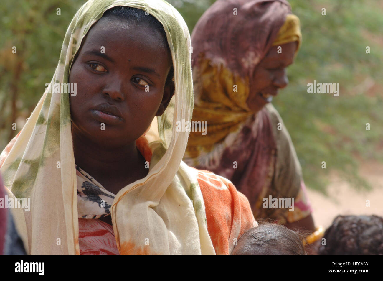 A local villager from Petit Douda stands by as Marines and Sailors ...