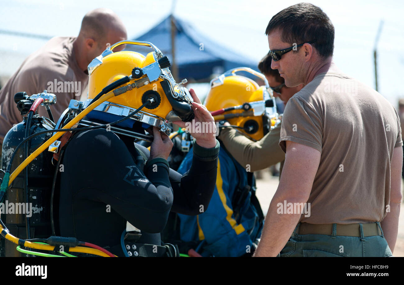 150514-N-OD763-014  VIRGINIA BEACH, Va. (May 14, 2015) – Navy Diver 1st Class Pete Kozminsky (right) assists Navy Diver 1st Class Calum Sanders, assigned to Mobile Diving Salvage Unit (MDSU) 2, don a Kirby Morgan 37 dive helmet during diver training at Joint Expeditionary Base Little Creek-Fort Story, Virginia Beach, Va., May 14. During this training, MDSU 2 divers prepare for an upcoming assignment to salvage of the Civil War ironclad Confederate State Ship (CSS) Georgia in the Savannah River, located in Savannah, Ga., June 1-July 20. (U.S. Navy photo by Mass Communication Specialist 2nd Clas Stock Photo