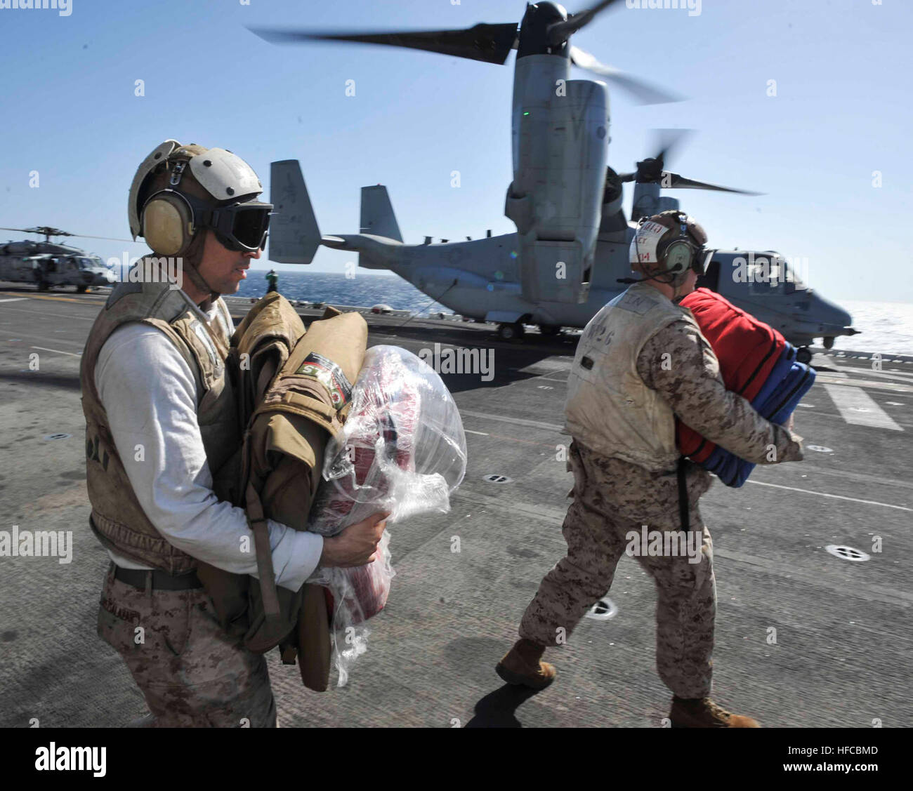 Marines help move medical supplies on the flight deck of the amphibious assault ship USS Boxer (LHD 4). Boxer is the flagship for the Boxer Amphibious Ready Group and, with the embarked 13th Marine Expeditionary Unit, is deployed in support of maritime security operations and theater security cooperation efforts in the U.S. 5th Fleet area of responsibility. (U.S. Navy Photo by Mass Communication Specialist 3rd Class J. Michael Schwartz/Released) Medical Emergency Response Team 131231-N-QP351-002 Stock Photo