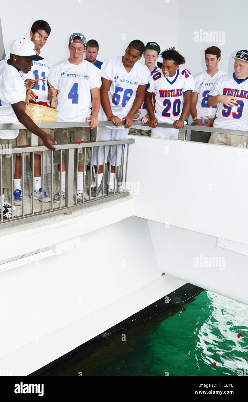 California's Westlake High School Football Team players drop flower petals in the water in honor of Lt. j.g. Francis L. Toner IV and Spc. A.J. Castro during a memorial held at the USS Arizona Memorial. Toner and Castro, graduates of Westlake, died during Operation Enduring Freedom. (U.S. Navy photo by Christine Rosalin/Released). Memorial for Lt. j.g. Francis L. Toner IV and Spc. A.J. Castro 130813-N-IX566-047 Stock Photo