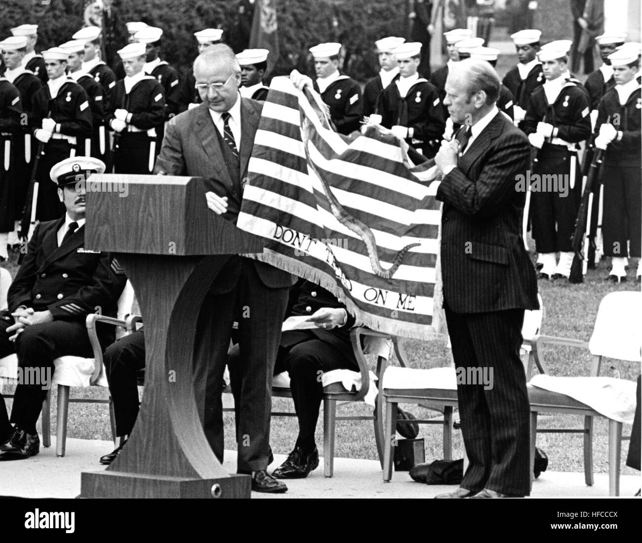 751029-N-ZZ999-101 WASHINGTON (Oct. 29, 1975) President Gerald R. Ford receives the prototype of the ceremonial Continental Navy Jack from Secretary of the Navy J. William Middendorf, II during a ceremony in Washington. A smaller version of the flag was flown from the jack staff of every U.S. Navy ship in December 1976 as part of the Navy's Bicentennial Celebration. (U.S. Navy photo by Chief Journalist Richard Montgomery/Released) Middendorf-Ford Flag (751029-N-ZZ999-101) Stock Photo