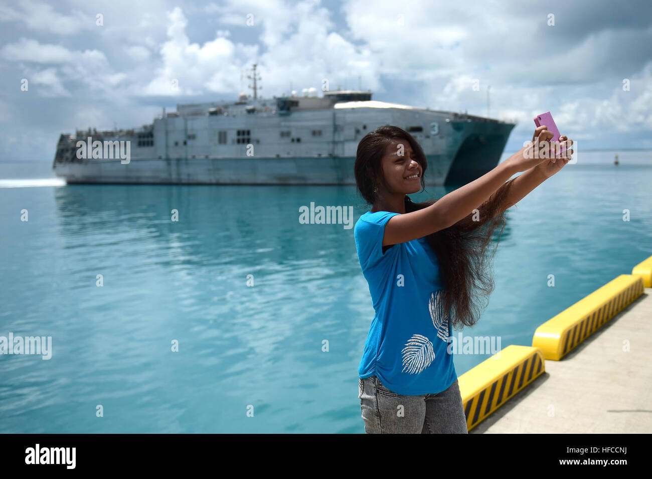 150602-N-HY254-027 TARAWA, Kiribati (June 2, 2015) An I-Kiribati girl pose for a “selfie” as the Military Sealift Command joint high-speed vessel USNS Millinocket (JHSV 3) arrives in Tarawa, Republic of Kiribati in support of Pacific Partnership 2015.  Tarawa is an atoll and the capital of the Republic of Kiribati, in the central Pacific Ocean and is the first country Millinocket will visit during PP15.  Now in its tenth iteration, Pacific Partnership is the largest annual multilateral humanitarian assistance and disaster relief preparedness mission conducted in the Indio-Asia-Pacific region.  Stock Photo