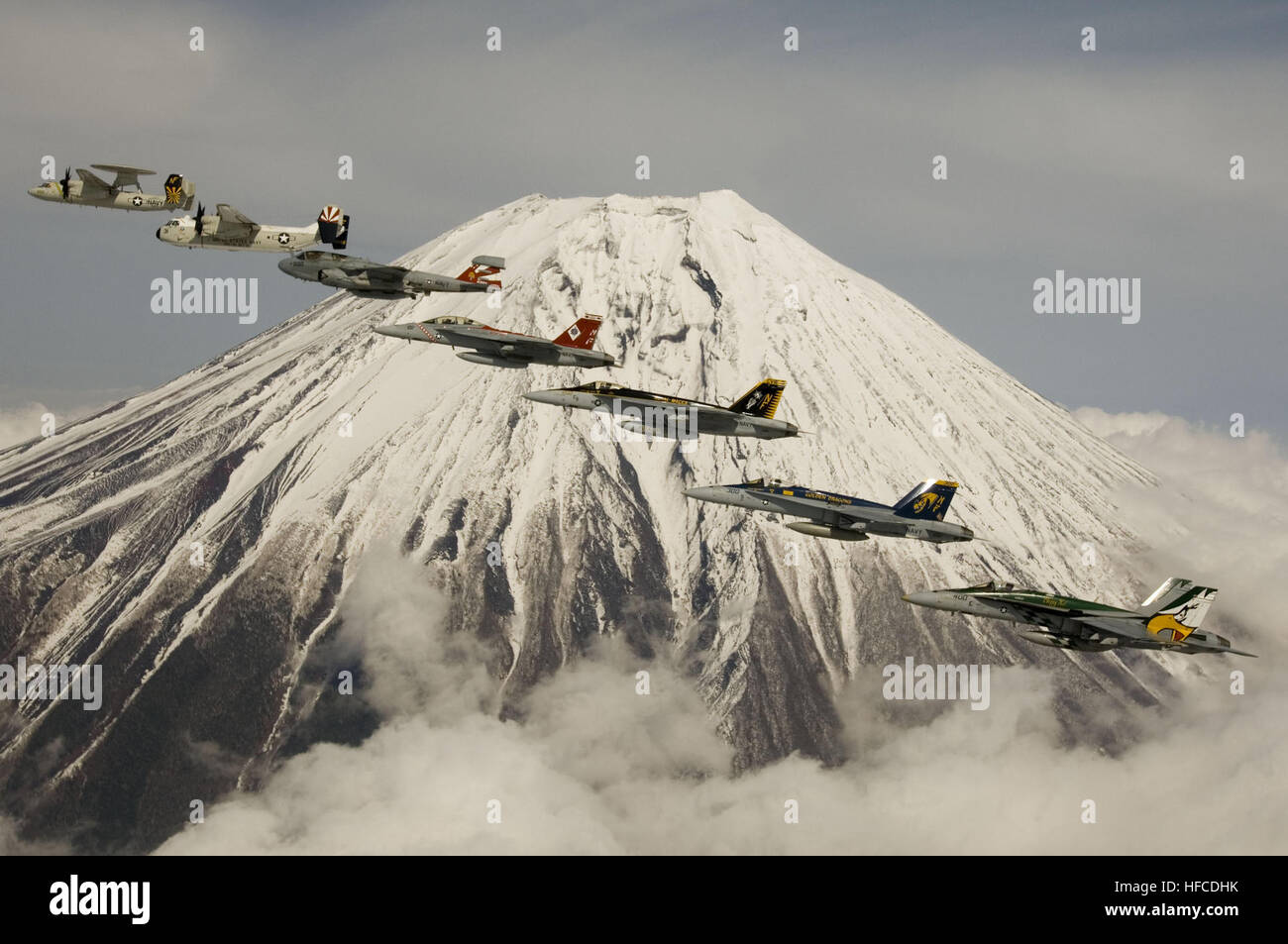 U.S. Navy aircraft from Carrier Air Wing Five perform a formation flight in front of Mount Fuji, Japan, April 12, 2007.  The air wing consists of the Diamondbacks of Strike Fighter Squadron (VFA) One Zero Two, the Dambussters of VFA 195, the Royal Maces of VFA 27, the Golden Dragons of VFA 192, the Liberty Bells of Carrier Airborne Early Warning Squadron One One Five, the Providers of Fleet Logistics Support Squadron Three Zero, the Gauntlets from Electronic Warfare Squadron One Three Six, the Warlordsof Helicopter Anti-Submarine Squadron Light Fifty, not shown, and the Chargers of Helicopter  Stock Photo