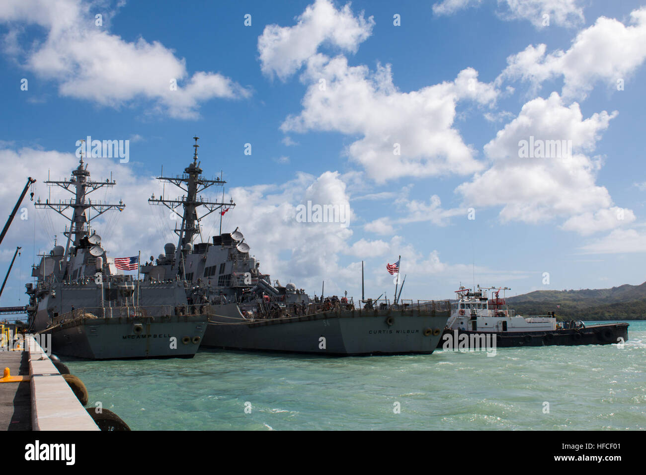 APRA HARBOR, Guam (March 4, 2016) – The destroyer USS Curtis Wilbur (DDG-54), gets tugged next to USS McCampbell (DDG-85) at Apra Harbor, U.S. Naval Base Guam, for a short in-port period prior to the bilateral exercise Multi-Sail 2016 (MS-16).  Ten total naval surface combatants assigned to the U.S. and Japanese navies arrived in-port to Apra Harbor, increasing the total number of visiting and home-ported vessels at the base to 20 and marked the largest contingent of vessels in Apra Harbor in more than 30 years. (Released/Jeff Landis, Major, USMC (Ret.), Director of Public Affairs/Communicatio Stock Photo