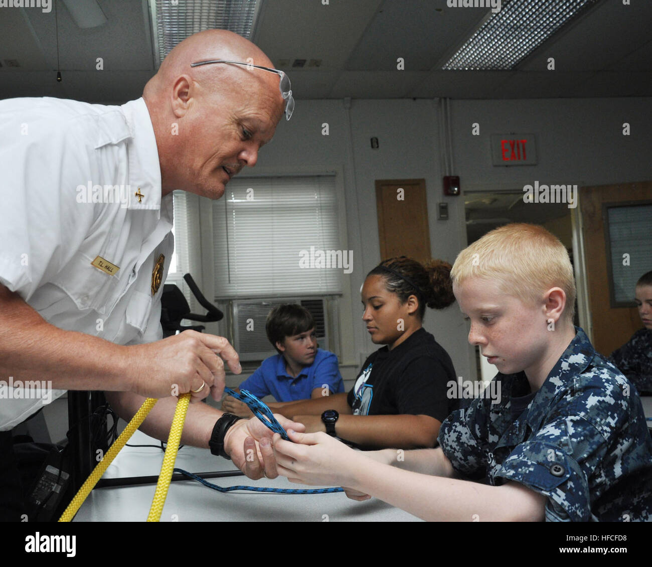 130608-N-CE356-004 USA (Jun. 8, 2013) Naval Support Faciilty (NSF) Dahlgren fire department battalion chief Tracy Hall offers some knot-tying pointers to Navy League Cadet LC2 Michael Feeser.  The training was part of a monthly drill weekend for the Pentagon Division of the U.S. Naval Sea Cadet Corps, which is hosted on NSF Dahlgren by Naval Support Activity South Potomac. (U.S. Navy photo by Andrew Revelos/Released) Naval Support Facility (NSF) Dahlgren fire department battalion chief Tracy Hall offers some knot-tying pointers to a Navy League cadet Stock Photo