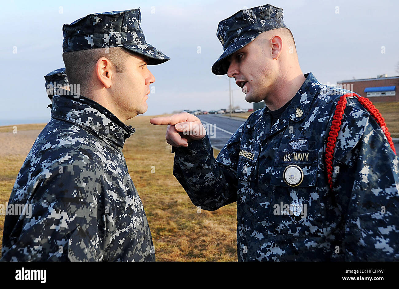 Senior Chief Aviation Machinist's Mate Robert Demanuele, a recruit division commander at Officer Training Command, instructs a Navy officer candidate from Officer Candidate School on proper grooming standards during morning quarters at Naval Station Newport. Navy chiefs mold officers at Officer Training Command 120223-N-CD297-142 Stock Photo
