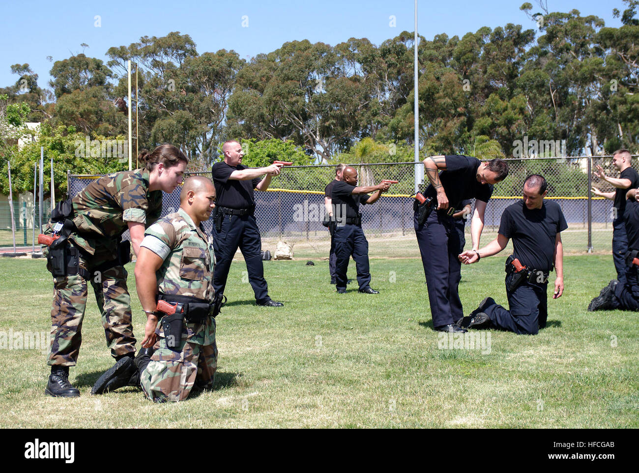 Navy law enforcement members participate in apprehension techniques during the Navy Security Forces Training Course at Naval Air Station North Island. The pilot program simultaneously trains civilian and military police forces during a nine-week course, which enables the different law enforcement agencies to successfully work together during operations. (Photo by: Petty Officer 3rd Class Spencer Mickler) Navy Security Forces Training Course 276884 Stock Photo