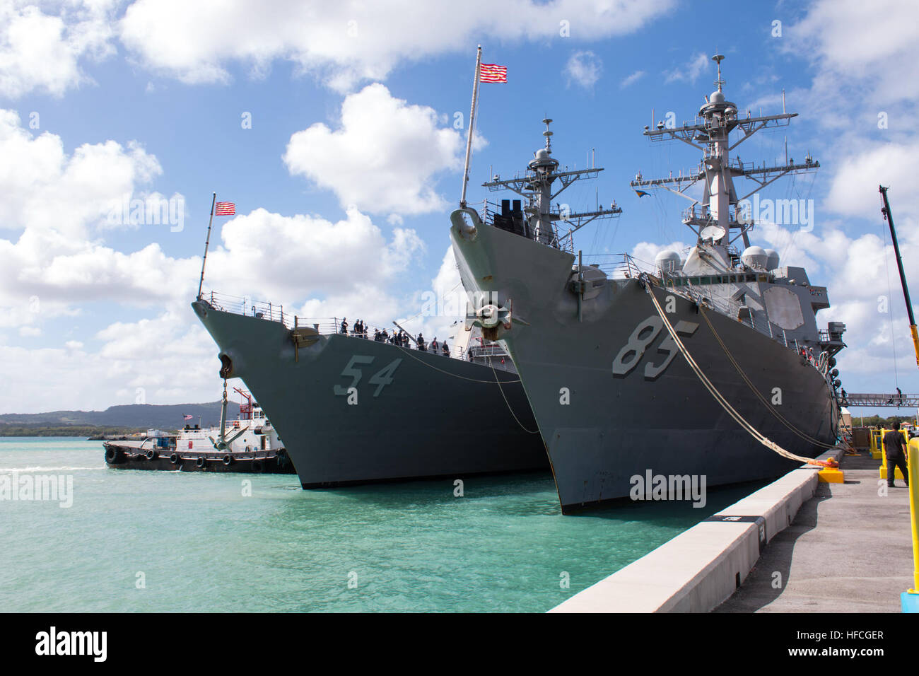 APRA HARBOR, Guam (March 4, 2016) – The destroyer USS Curtis Wilbur (DDG-54), gets tugged next to USS McCampbell (DDG-85) at Apra Harbor, U.S. Naval Base Guam, for a short in-port period prior to the bilateral exercise Multi-Sail 2016 (MS-16). Ten total naval surface combatants assigned to the U.S. and Japanese navies arrived in-port to Apra Harbor, increasing the total number of visiting and home-ported vessels at the base to 20 and marked the largest contingent of vessels in Apra Harbor in more than 30 years. (Released/Jeff Landis, Major, USMC (Ret.), Director of Public Affairs/Communication Stock Photo