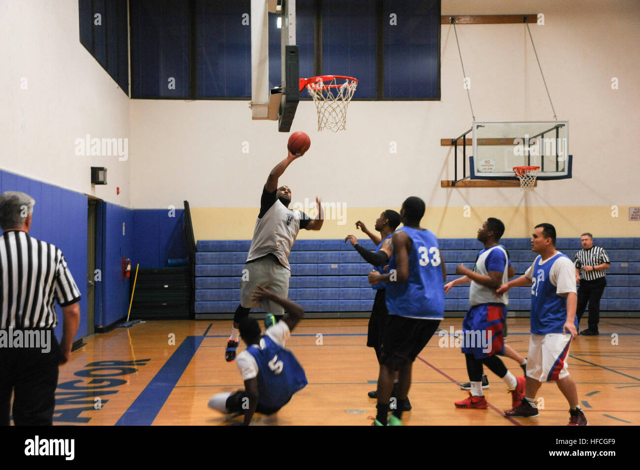 Patrick Lewis, a military family member and Pink Towels number 9, shoots a bank shot during a Morale Welfare and Recreation intramural sports preseason championship basketball game at Naval Base Kitsap Bangor Fitness Center. The Navy's intramural sports program follows the motto 'Fitness for Life' providing another outlet to promote fitness and establish espirit de corps. (U.S. Navy photo by Mass Communication Specialist 2nd Class Cory Asato/Released) NBK MWR hosts championship basketball game 150121-N-OO032-044 Stock Photo