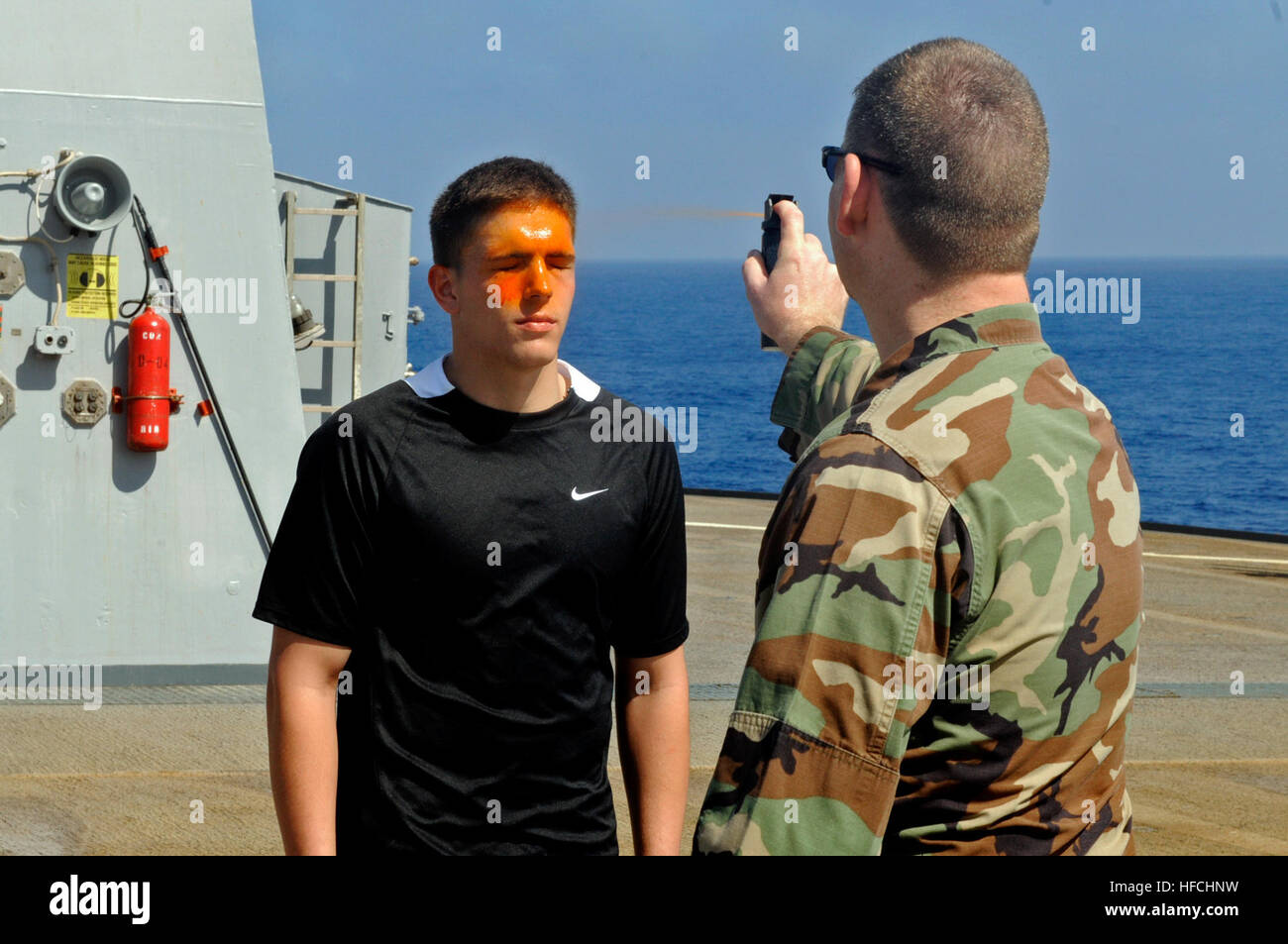 Chief Petty Officer Master-at-Arms Jerry D. Tullos sprays Seaman Chad ...