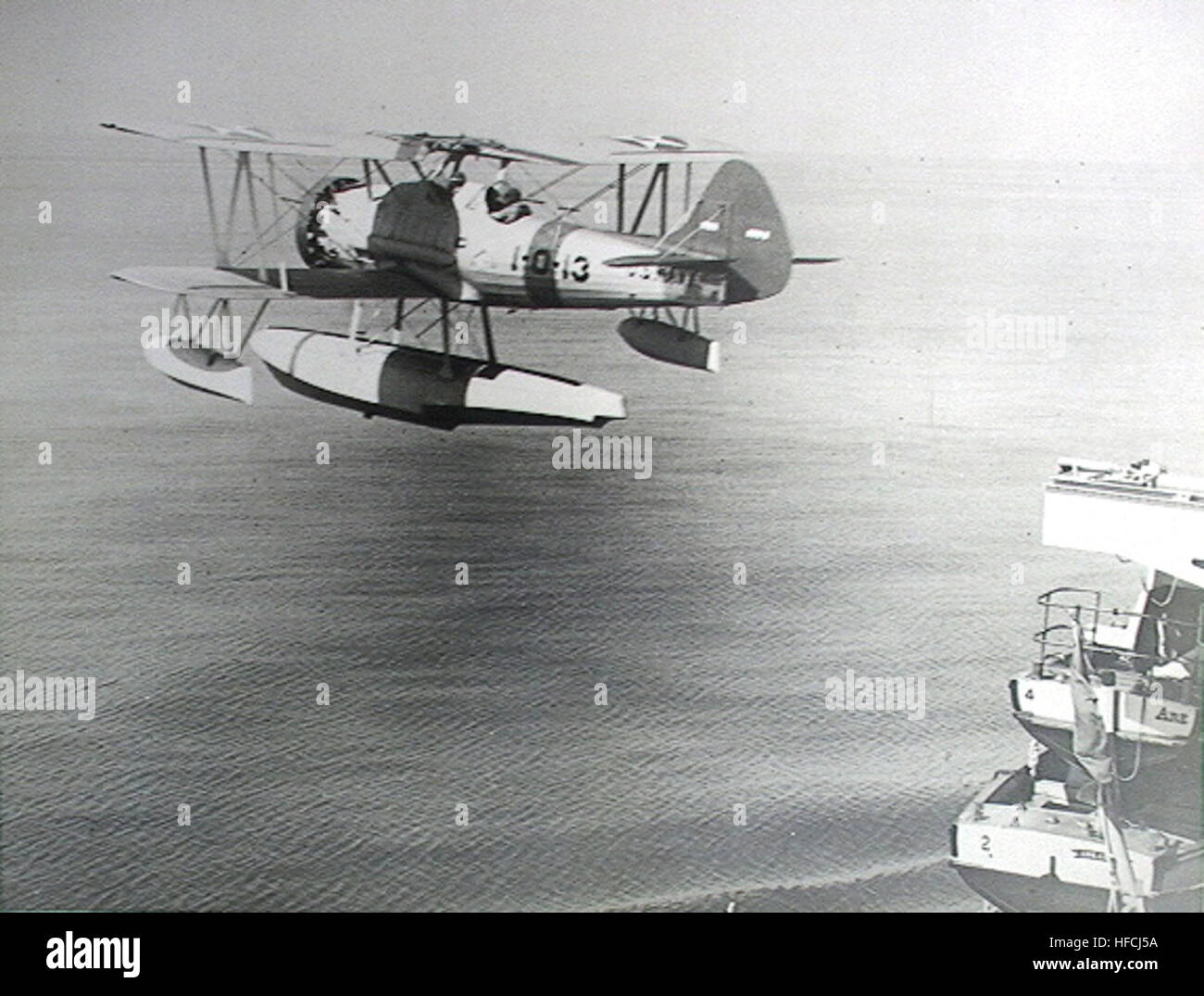 An O3U biplane aircraft is launched from the battleship USS Arkansas ...