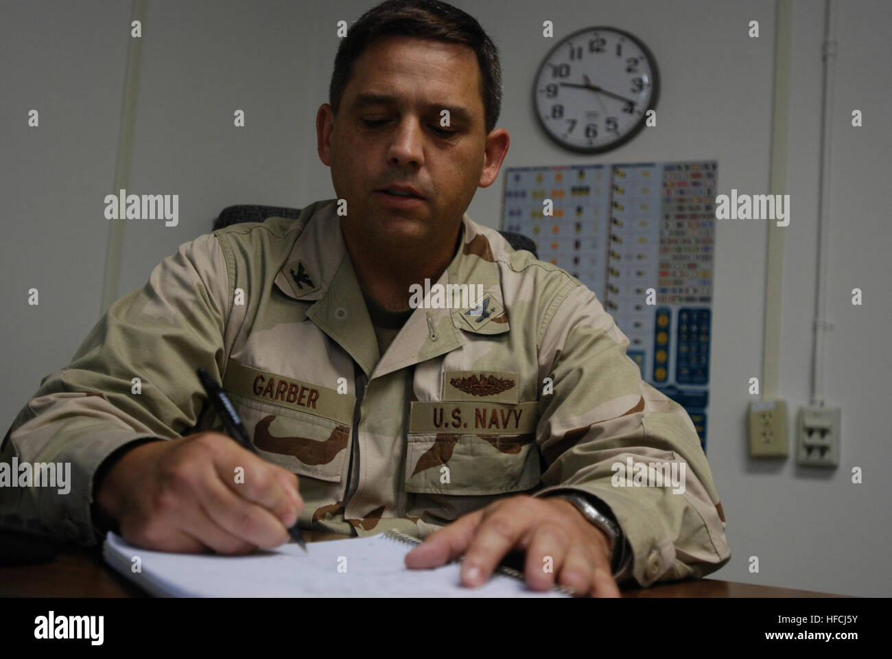 GUANTANAMO BAY, Cuba - Navy Capt. Ken Garber, officer in charge of the Office for the Administrative Review of the Detention of Enemy Combatants-Forward, reviews documents in his office on U.S. Naval Station Guantanamo Bay June 3, 2008. OARDEC makes recommendations to the Deputy Secretary of Defense on whether to release, transfer or continue to detain detainees in Guantanamo Bay. JTF Guantanamo conducts safe and humane care and custody of detained enemy combatants. The JTF conducts interrogation operations to collect strategic intelligence in support of the Global War on Terror and supports l Stock Photo