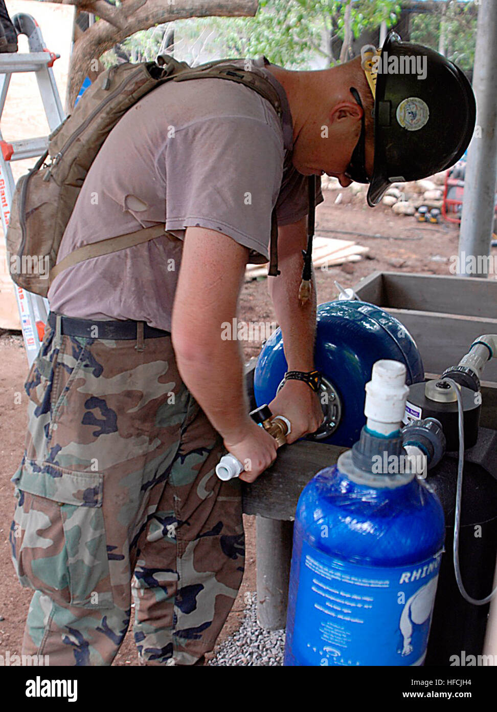 Utilitiesman 3rd Class Tomas Thompson, assigned to Construction Battalion Maintenance Unit 303, embarked aboard the amphibious assault ship USS Boxer (LHD 4), places finishing touches on a kitchen water purifier during the restoration of the Canton el Sunza school house during Continuing Promise 2008. Boxer is deployed supporting the Pacific phase of CP, an equal partnership mission between the United States, Guatemala, El Salvador and Peru. Operations aboard USS Boxer 91656 Stock Photo