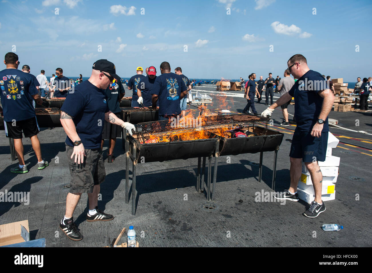 Chief Petty Officers grill food for a steelbeach picnic on the flight