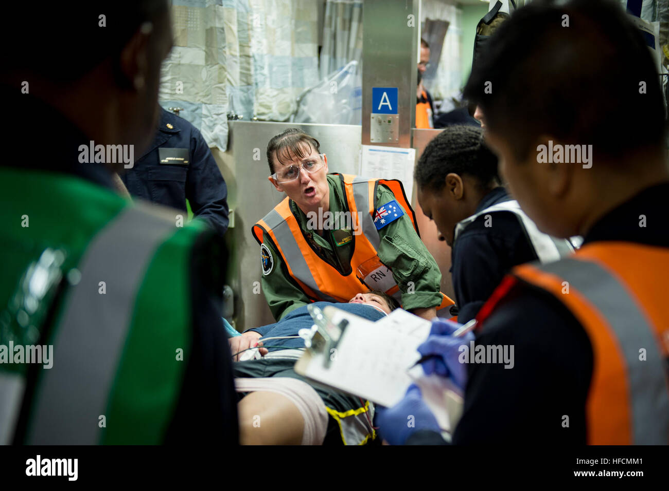 160624-N-QW941-155  PHILIPPINES SEA (June 24, 2016) Squadron Leader Lynette Howell (center), a nurse in the Royal Australian Air Force and native of Newcastle, Australia, communicates with personnel aboard hospital ship USNS Mercy (T-AH 19) during a mass casualty drill. Deployed in support of Pacific Partnership 2016, medical, engineering and various other personnel embarked aboard Mercy are working side-by-side with partner nation counterparts, exchanging ideas, building best practices and relationships to ensure preparedness should disaster strike. (U.S. Navy photo by Mass Communication Spec Stock Photo