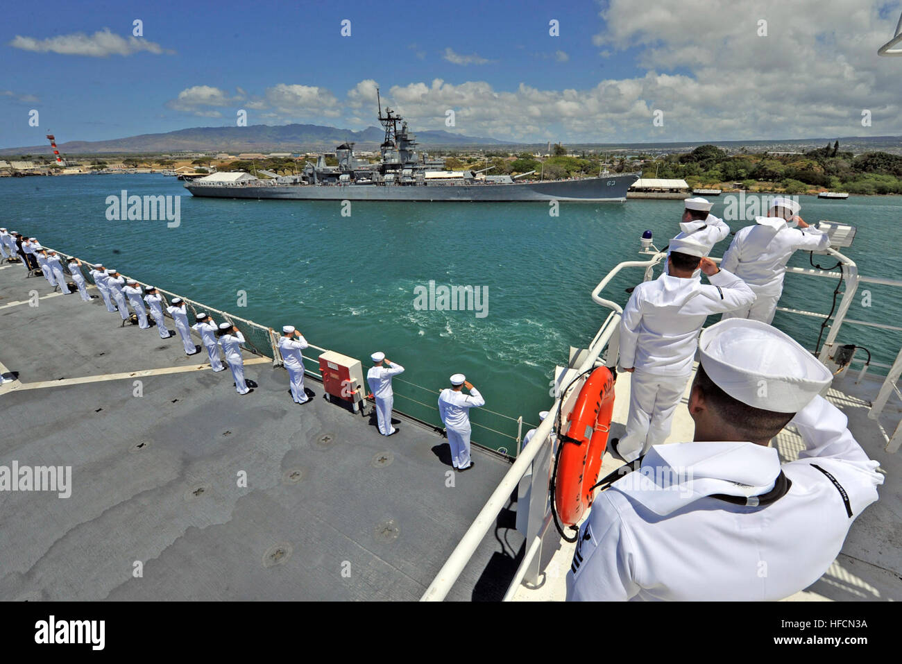 Service members render honors to the battleship USS Missouri from the ...
