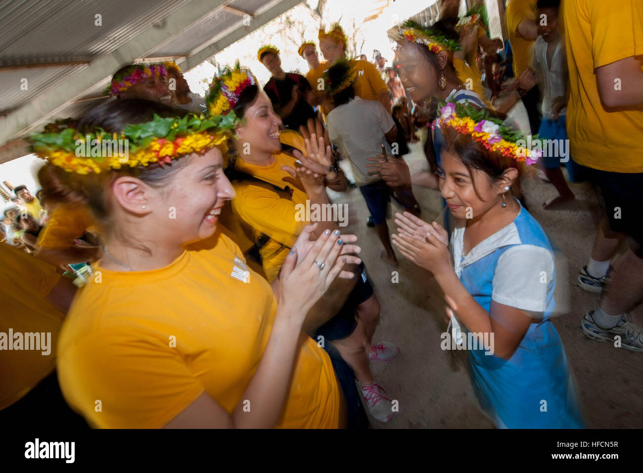 130718-N-HA376-625 TARAWA, Kiribati (July 18, 2013) Engineman Fireman Recruit Vivian Anaya dances with a student at the Taaken Bairiki Primary School during a Pacific Partnership 2013 community service event. Working at the invitation of each host nation, U.S. Navy forces are joined by non-governmental organizations and regional partners that include Australia, Canada, Colombia, France, Japan, Malaysia, Singapore, South Korea and New Zealand to improve maritime security, conduct humanitarian assistance and strengthen disaster-response preparedness. (U.S. Navy photo by Mass Communication Specia Stock Photo