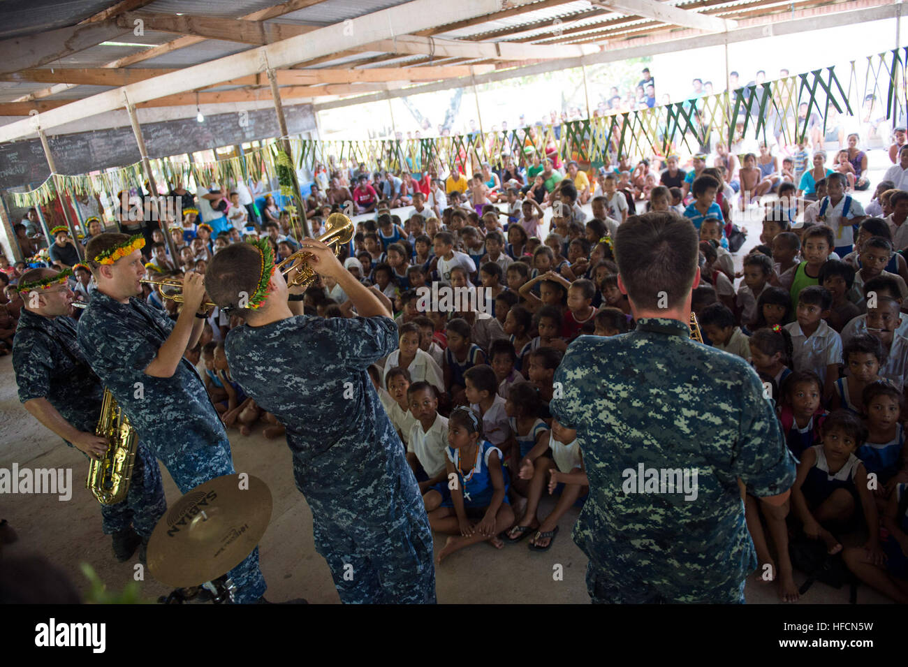 130718-N-WD757-515 TARAWA, Kiribati (July 18, 2013) The U.S. Navy Pacific Fleet Band perform for students at St. John Bosco Taaken Bairiki Primary School during a community service project during Pacific Partnership 2013. Working at the invitation of each host nation, U.S. Navy forces are joined by non-governmental organizations and regional partners that include Australia, Canada, Colombia, France, Japan, Malaysia, Singapore, South Korea, and New Zealand to improve maritime security, conduct humanitarian assistance and strengthen disaster-response preparedness. (U.S. Navy photo by Mass Commun Stock Photo