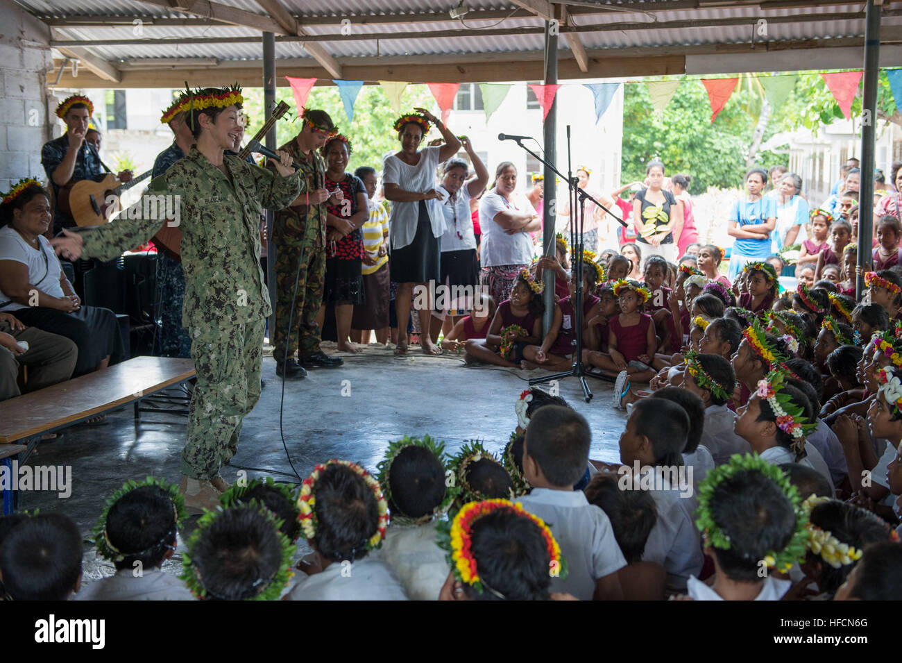 130724-N-SP369-198 TARAWA, Kiribati (July 24, 2013) Cmdr. Joyce Blanchard speaks to a group of children at a local primary school during a Pacific Partnership 2013 community service event. Working at the invitation of each host nation, U.S. Navy forces are joined by non-governmental organizations (NGOs) and regional partners that include Australia, Canada, Colombia, France, Japan, Malaysia, Singapore, South Korea and New Zealand to improve maritime security, conduct humanitarian assistance and strengthen disaster-response preparedness. (U.S. Navy photo by Mass Communication Specialist 3rd Clas Stock Photo