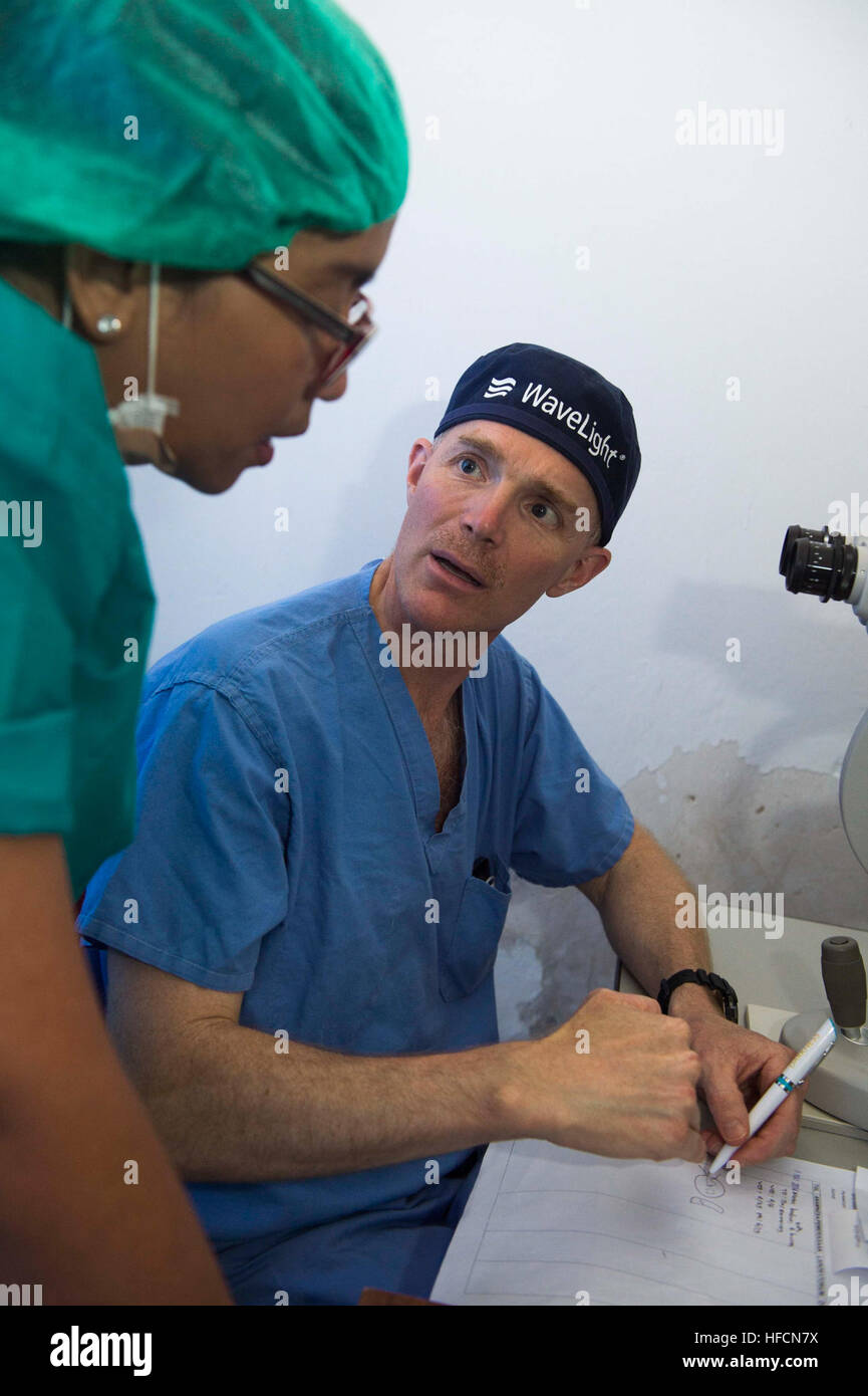 140528-N-IL267-152 BA'A, Indonesia (May 28, 2014) Ophthalmologist Miranda Johannes and U.S. Navy Cmdr. Brice Nicholson, an ophthalmologist from Gig Harbor, Wash., assigned to Naval Hospital Bremerton, discuss how to treat a patient complaining of blurry vision during a subject matter expert exchange at Ba’a Subdistrict General Hospital as part of Pacific Partnership 2014. Pacific Partnership is in its ninth iteration and is the largest annual multilateral humanitarian assistance and disaster relief preparedness mission conducted in the Asia-Pacific region. (U.S. Navy photo by Mass Communicatio Stock Photo