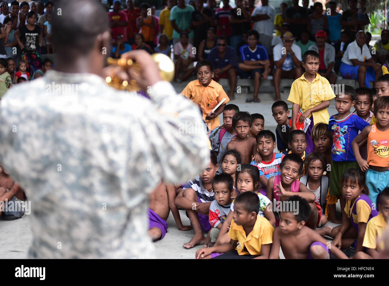 150604-N-HY254-163 TARAWA, Kiribati (June 4, 2015) U.S. Army Staff Sgt. Joshua Price from the 25th Infantry Division Band performs a trumpet solo at a concert held in Bairiki Square during a Pacific Partnership visit to the Independent Republic of Kiribati. Joint High Speed Vessel USNS Millinocket (JHSV 3) is serving as the secondary platform for Pacific Partnership, led by an expeditionary command element from the Navy’s 30th Naval Construction Regiment (30 NCR) from Port Hueneme, Calif. Now in its 10th iteration, Pacific Partnership is the largest annual multilateral humanitarian assistance  Stock Photo