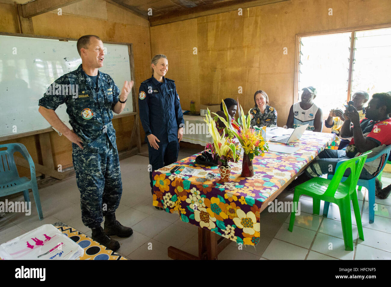 ARAWA, Autonomous Region of Bougainville, Papua New Guinea (July 2, 2015) Capt. Chris Engdahl, Pacific Partnership 2015 mission commander, and Royal New Zealand Air Force Wing Cmdr. Jennifer Atkinson, Pacific Partnership 2015 chief of staff, talk to Bougainville community leaders during a family violence prevention workshop at the Tuniva Learning Center. The group met to discuss how to prevent domestic violence abuse as part of the National Action Plan on Women, Peace and Security. The hospital ship USNS Mercy (T-AH 19) is currently at its second mission port of Papua New Guinea as part of Pac Stock Photo