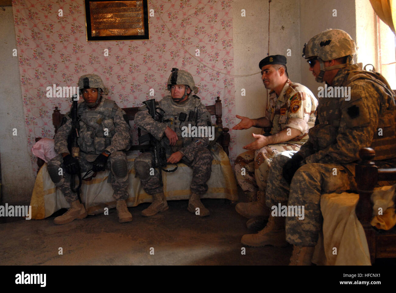 U.S. Soldiers attached to the 2nd Brigade, 1st Infantry Division, along with Iraqi soldiers with the 6th Iraqi army, meet with the Sons of Iraq at their headquarters in the province of Nassir Wa Salam in Abu Ghraib, Iraq, on May 16. Patrol in Abu Ghraib 174026 Stock Photo