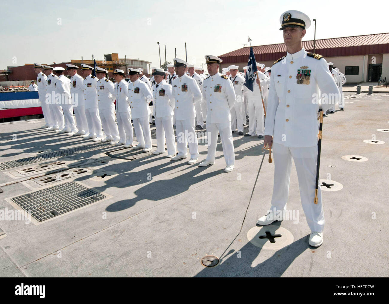 U.S. sailors, with Amphibious Construction Battalion 2, stand at parade ...